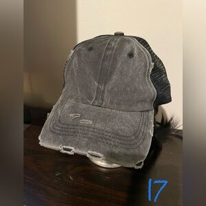 Unisex mesh trucker-style hat. Distressed black. Adjustable.